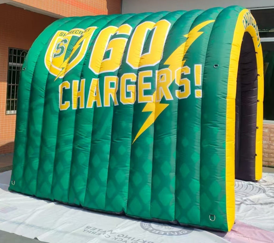 Green and yellow inflatable tunnel with "GO CHARGERS!" and Shorecrest logo
