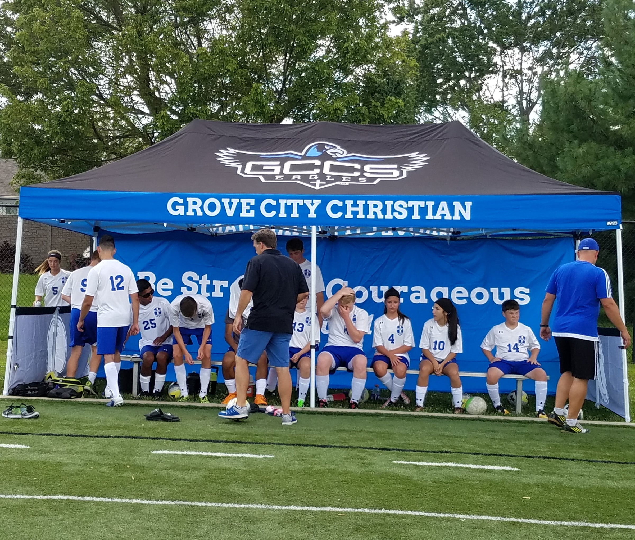 Grove City Christian custom 10x20 canopy tent for soccer team sideline cover with players seated underneath