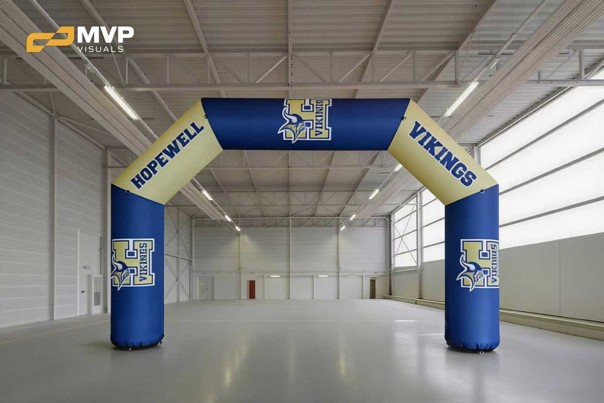 Custom blue and gold inflatable event arch with Hopewell Vikings logo displayed indoors for school sports entrance or race start line branding
