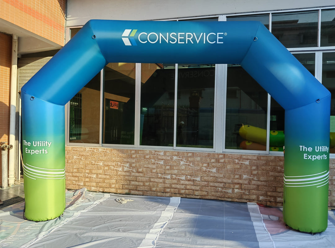 Blue and green inflatable arch with Conservice logo and “The Utility Experts” slogan