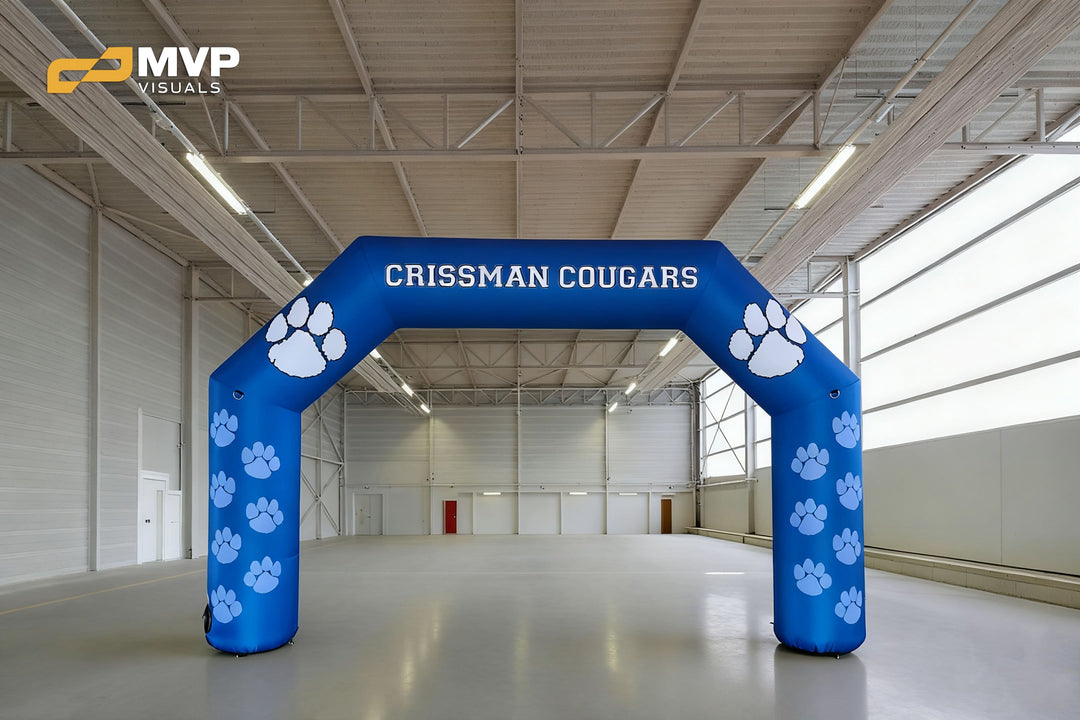 Blue inflatable arch with Crissman Cougars text and white paw prints