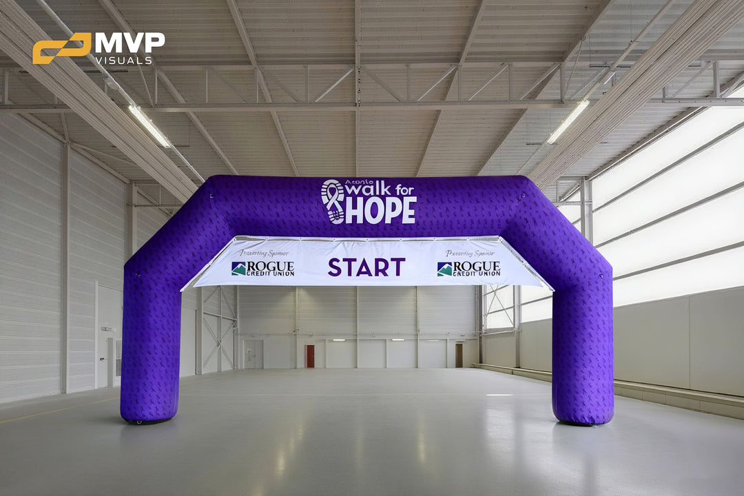 Purple inflatable arch with Walk for Hope and Rogue Credit Union logos