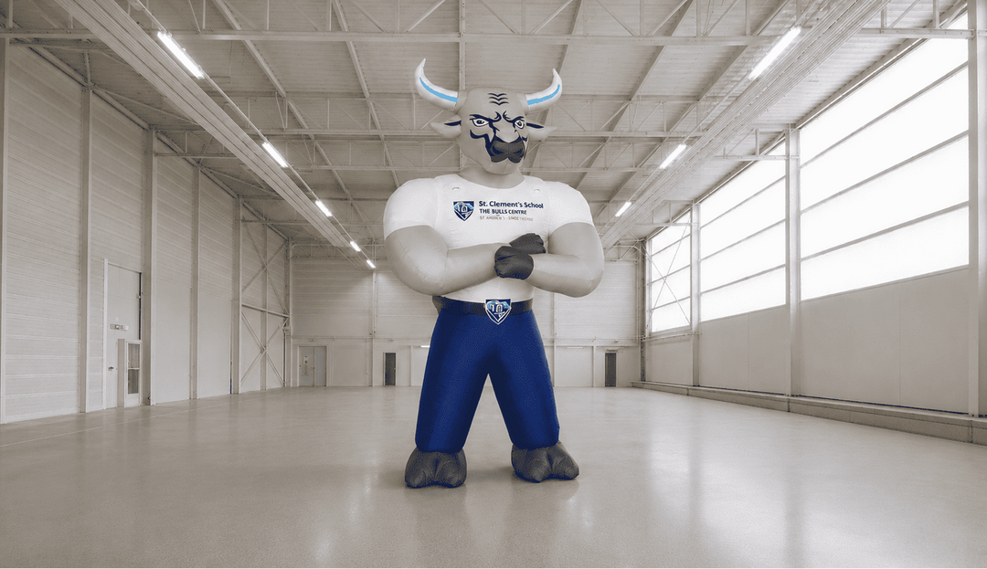 Mascot character in a large indoor space with 'MVP Visuals' branding.