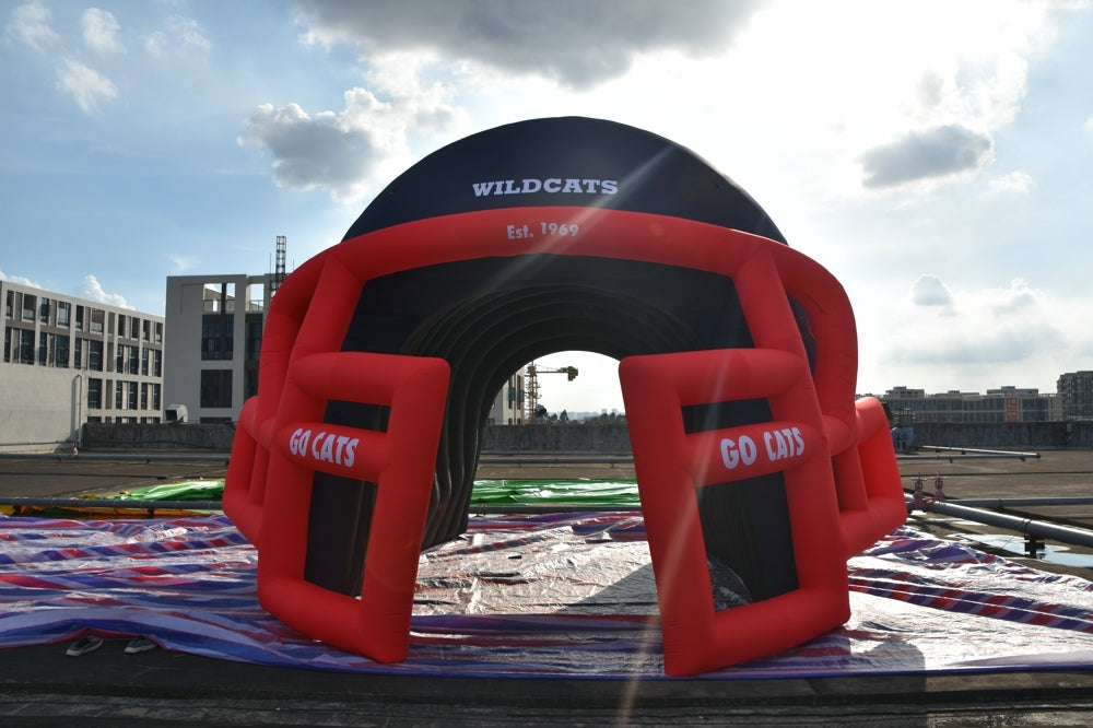 Inflatable helmet tunnel for Wildcats team with "Go Cats" signage and Est. 1969