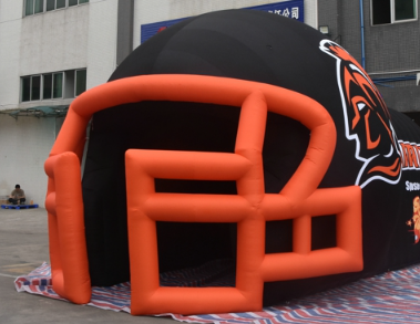 Inflatable football helmet tunnel with Warriors team logo and Roller Magic sponsorship