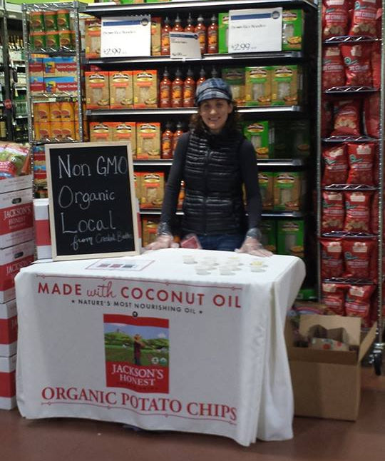 Jackson's Honest Chips organic potato chips sampling table with branded table cover in grocery store