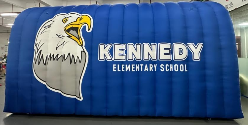 Blue inflatable tunnel with eagle mascot and Kennedy Elementary School logo for school events and student entrances