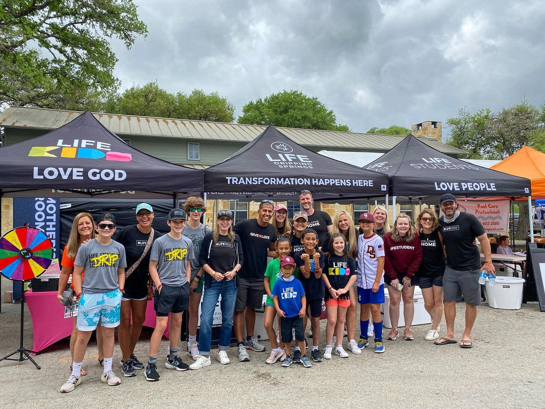 Life Church Dripping Springs group in front of Life Kids and Life Students tents
