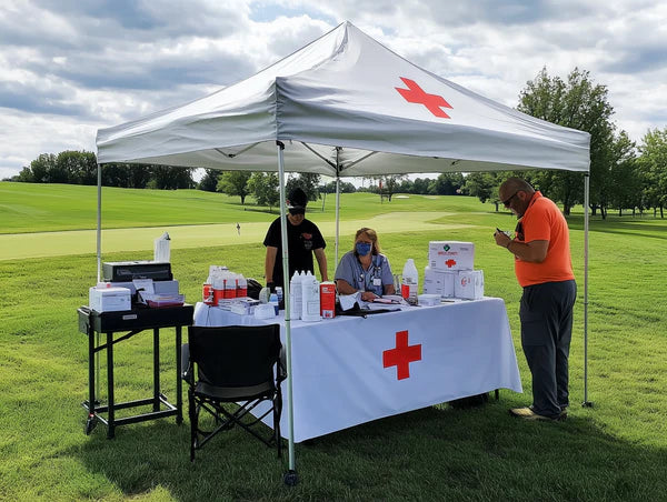 Medical support canopy tent setup with Red Cross branding at outdoor golf tournament event