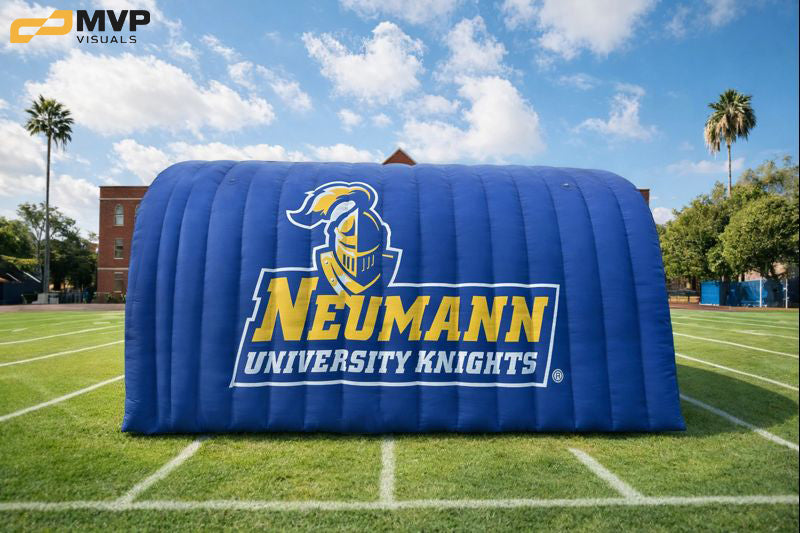 Inflatable structure with Neumann University Knights logo on a sports field