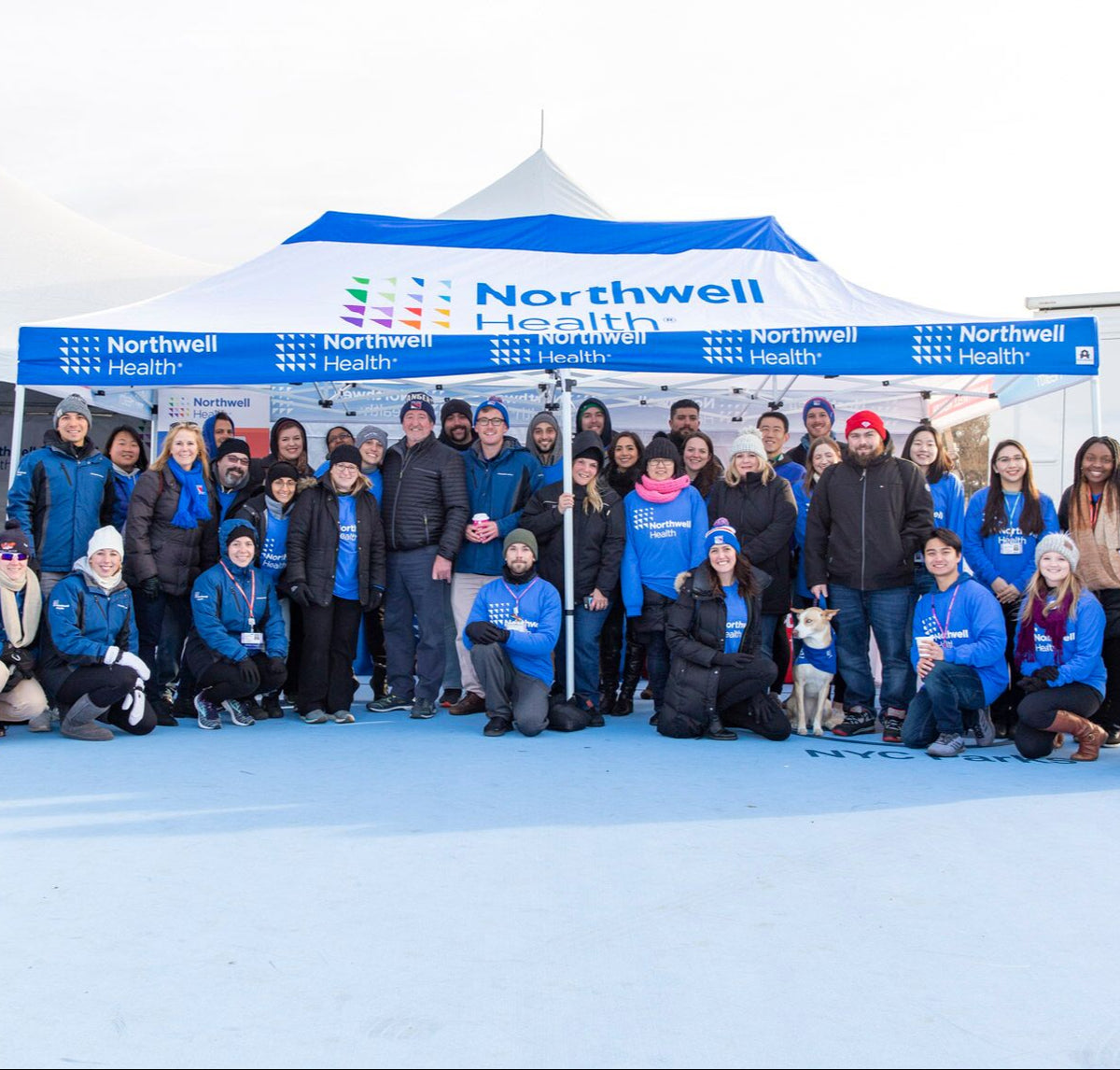 Northwell Health team gathered under branded canopy tent at outdoor winter event