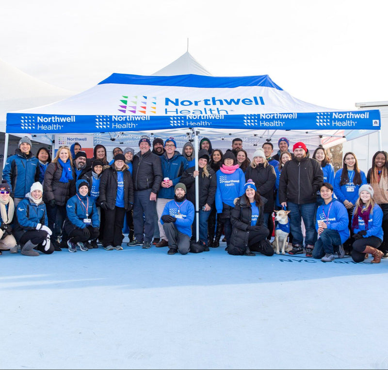 Northwell Health team under blue and white event tent
