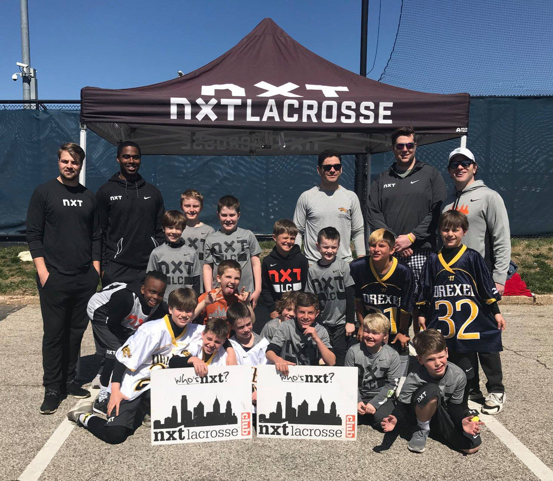 NXT Lacrosse 10x10 canopy tent with youth lacrosse team and coaches posing in front after event