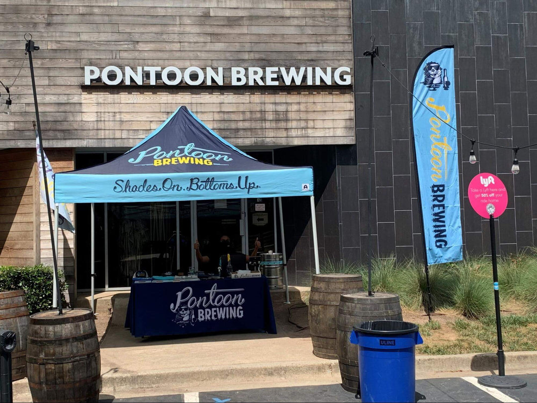 Branded outdoor restaurant tent at Pontoon Brewing for a cozy, shaded guest welcoming area