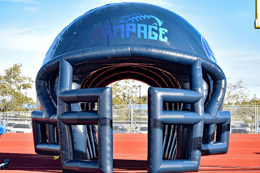 rampage inflatable football helmet tunnel on a track field