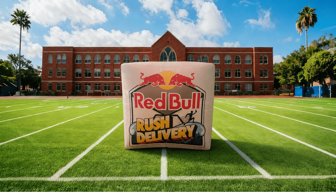 Red Bull Rush custom inflatable on a sports field with a building and palm trees in the background