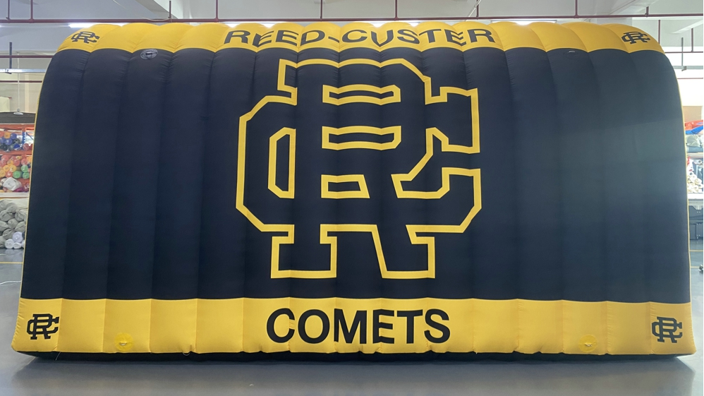 Black and yellow inflatable tunnel with Reed-Custer Comets logo for school sports entrances and team branding