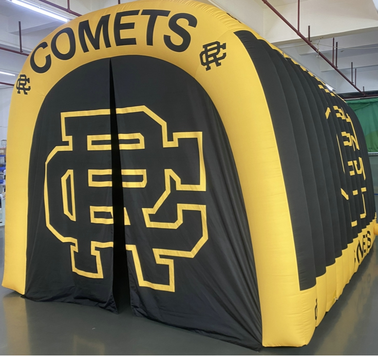 Angled view of black and yellow inflatable tunnel with Comets logo and bold RC lettering for Reed-Custer school events