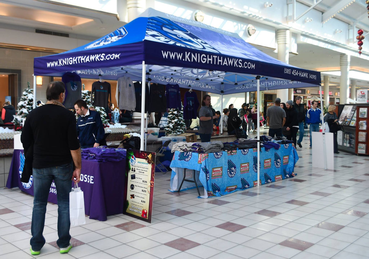 Rochester Knighthawks merchandise booth under custom tent inside shopping mall during holiday season