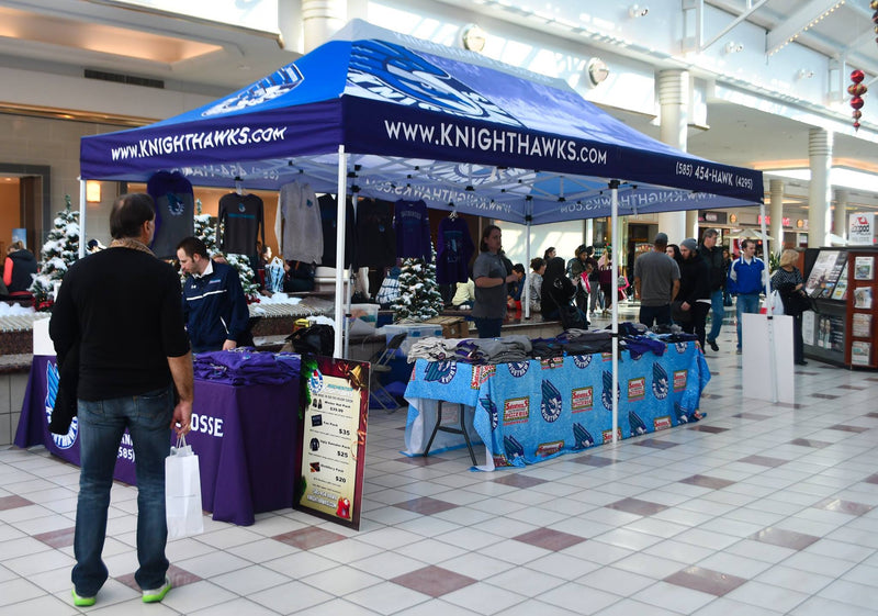Rochester Knighthawks merchandise booth with 10x15 custom canopy tent and branded table covers at indoor mall event