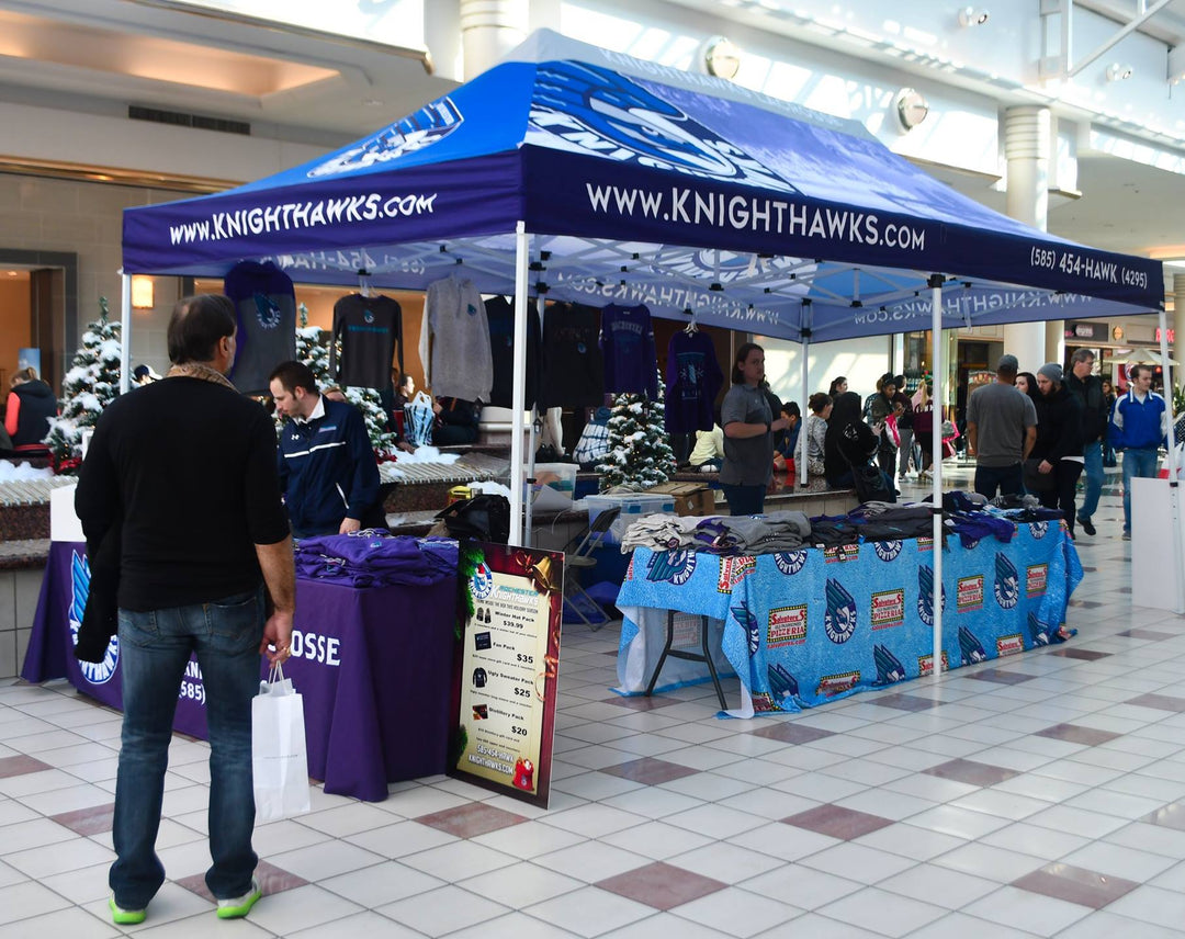 Rochester Knighthawks merchandise booth under custom tent inside shopping mall during holiday season