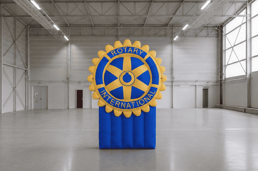 Large indoor warehouse with a prominent display of the Rotary International logo.