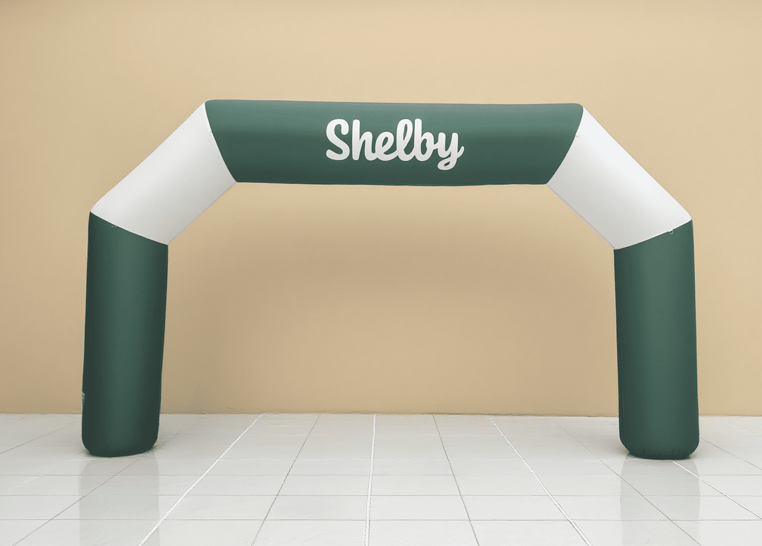Simple green and white inflatable arch with 'Shelby' text in white cursive font