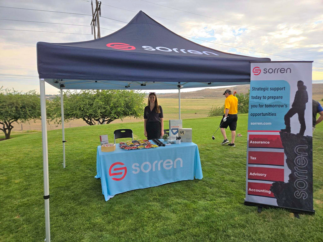 Sorren accounting firm canopy booth at a golf event with snacks and promotional materials on display