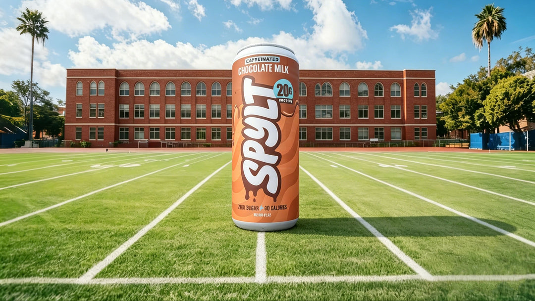 SPYLT chocolate milk can on a football field with a school building in the background