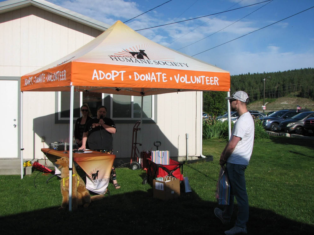 Spokane Humane Society custom canopy tent at pet adoption and volunteer event with booth setup and attendees