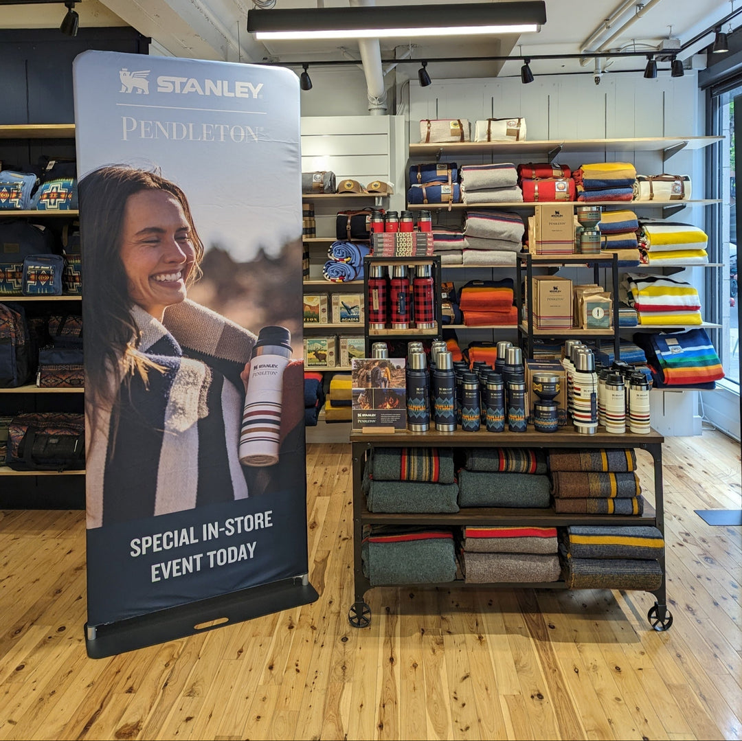 Stanley and Pendleton premium slip banner promoting in-store event beside merchandise display of thermoses and blankets