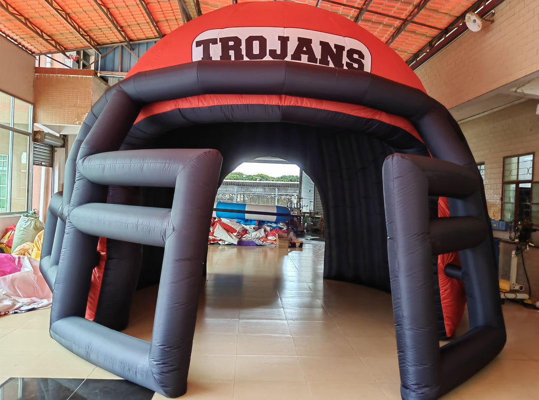 inflatable football helmet tunnel with Trojans logo in red and black