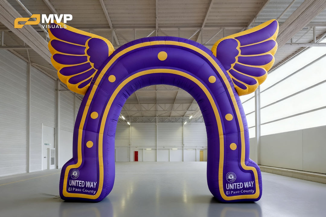 Purple and yellow inflatable arch with wings for United Way El Paso County