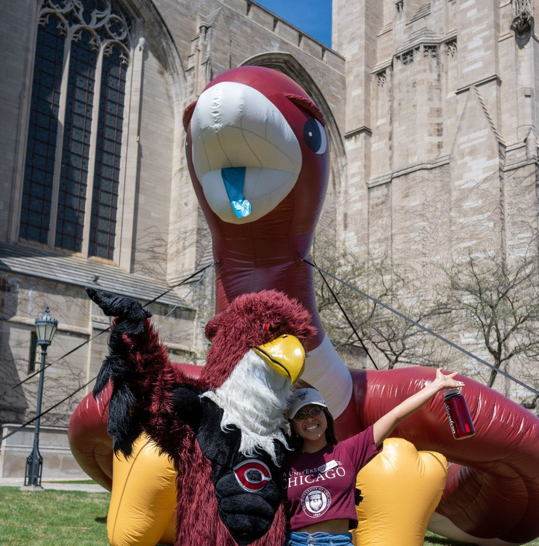 University of Chicago inflatable maroon hawk mascot with student and costumed mascot