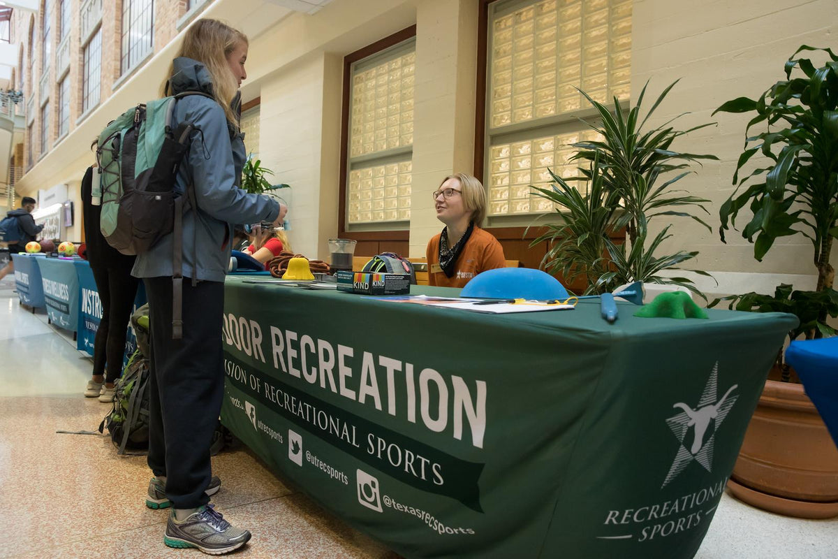 Person interacting with a table labeled 'Recreation' in an indoor setting