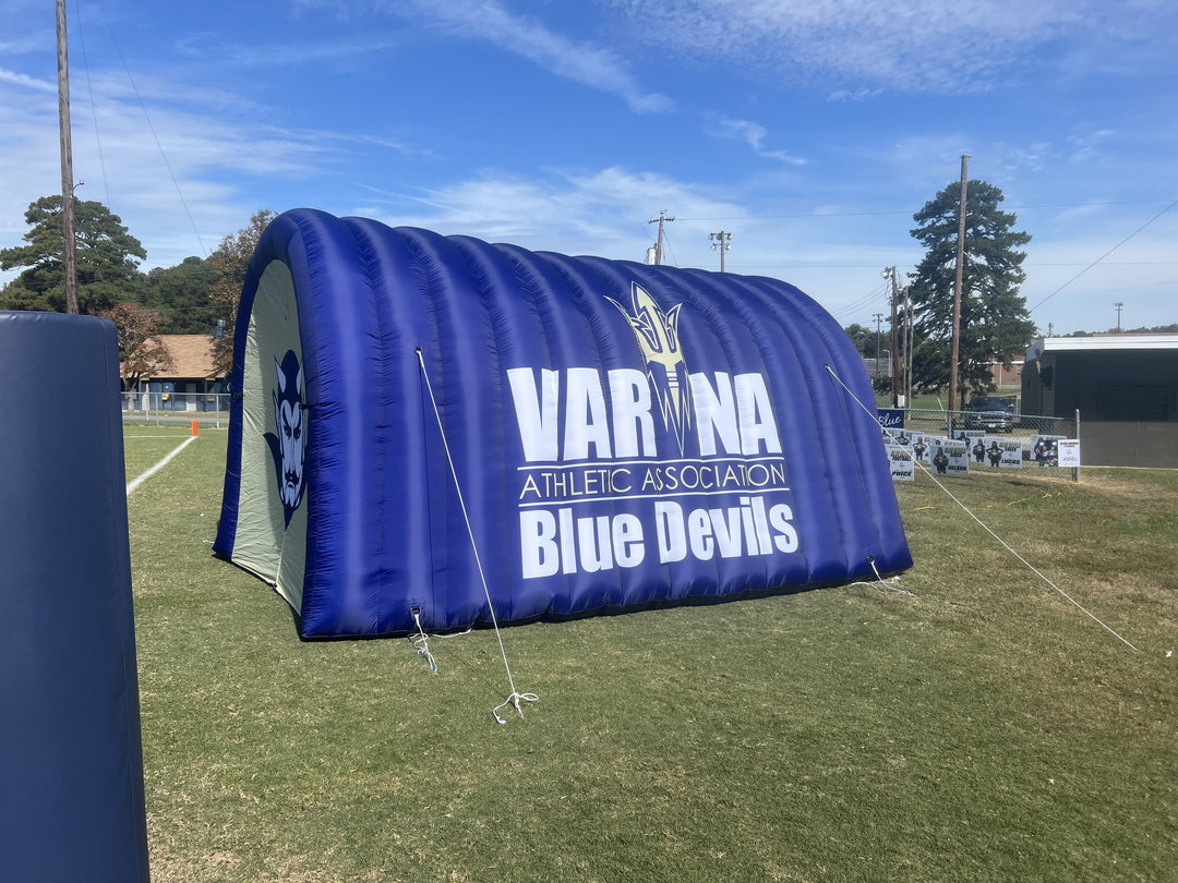 Empty Varina Blue Devils inflatable football tunnel on grassy field