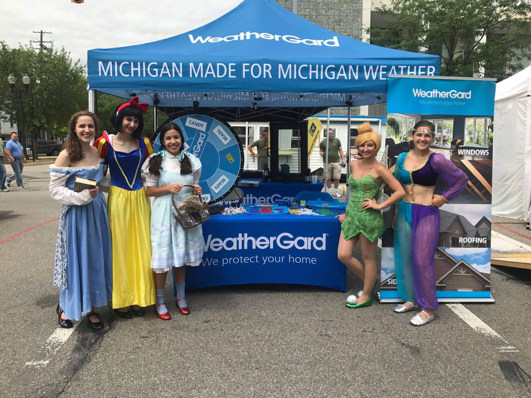 WeatherGard custom canopy tent at Michigan community fair with princess characters and branded booth setup