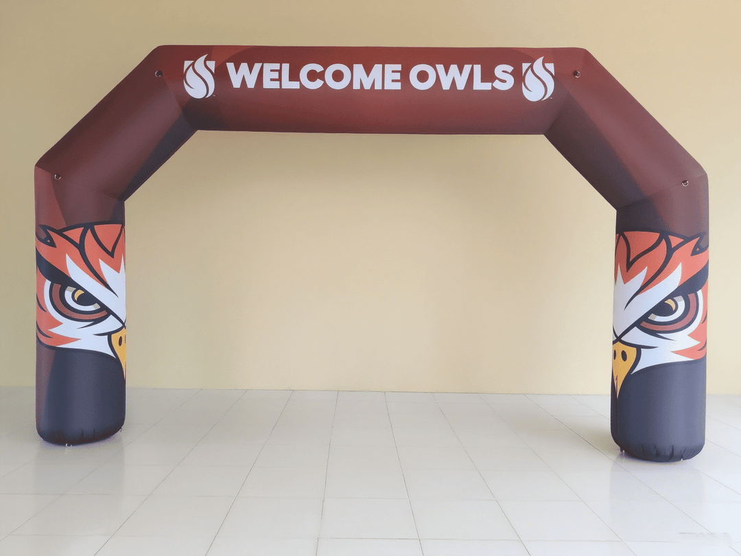 Maroon inflatable arch with owl eyes design and 'Welcome Owls' text